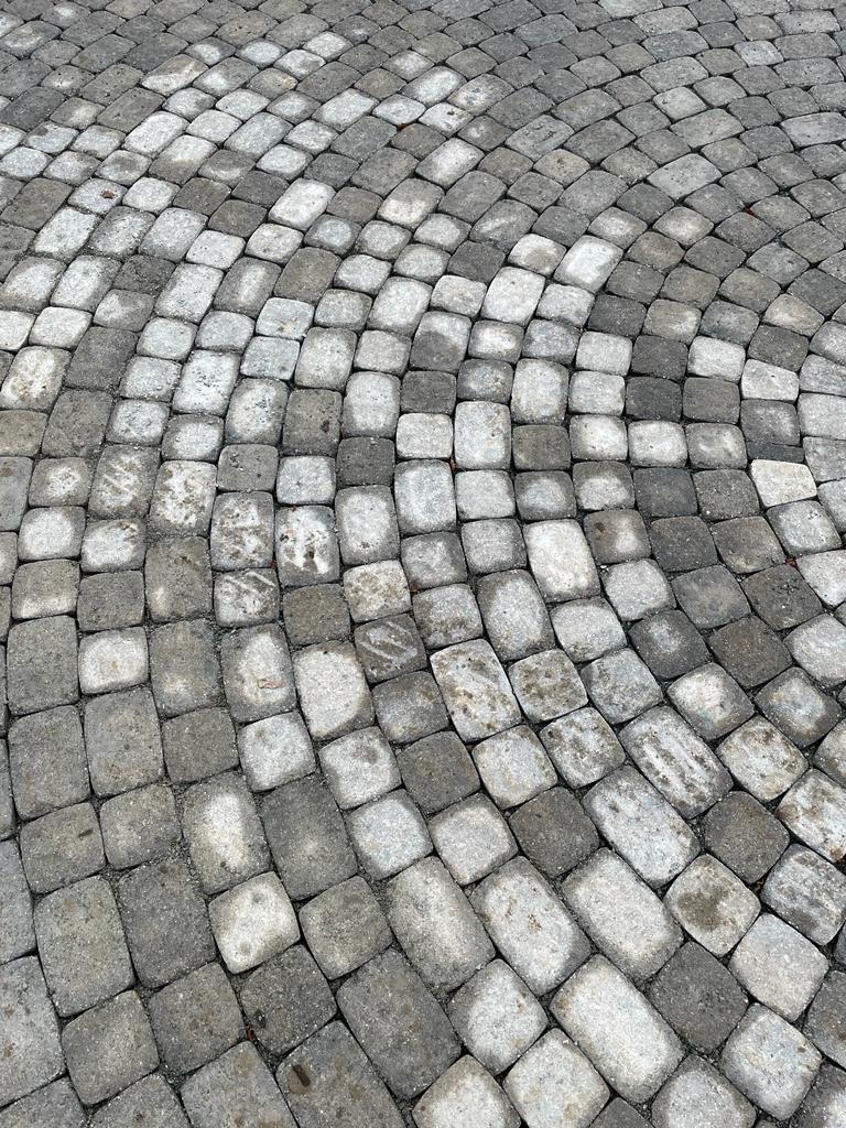 Granite cobblestone sett circular fan pattern close-up, Surrey