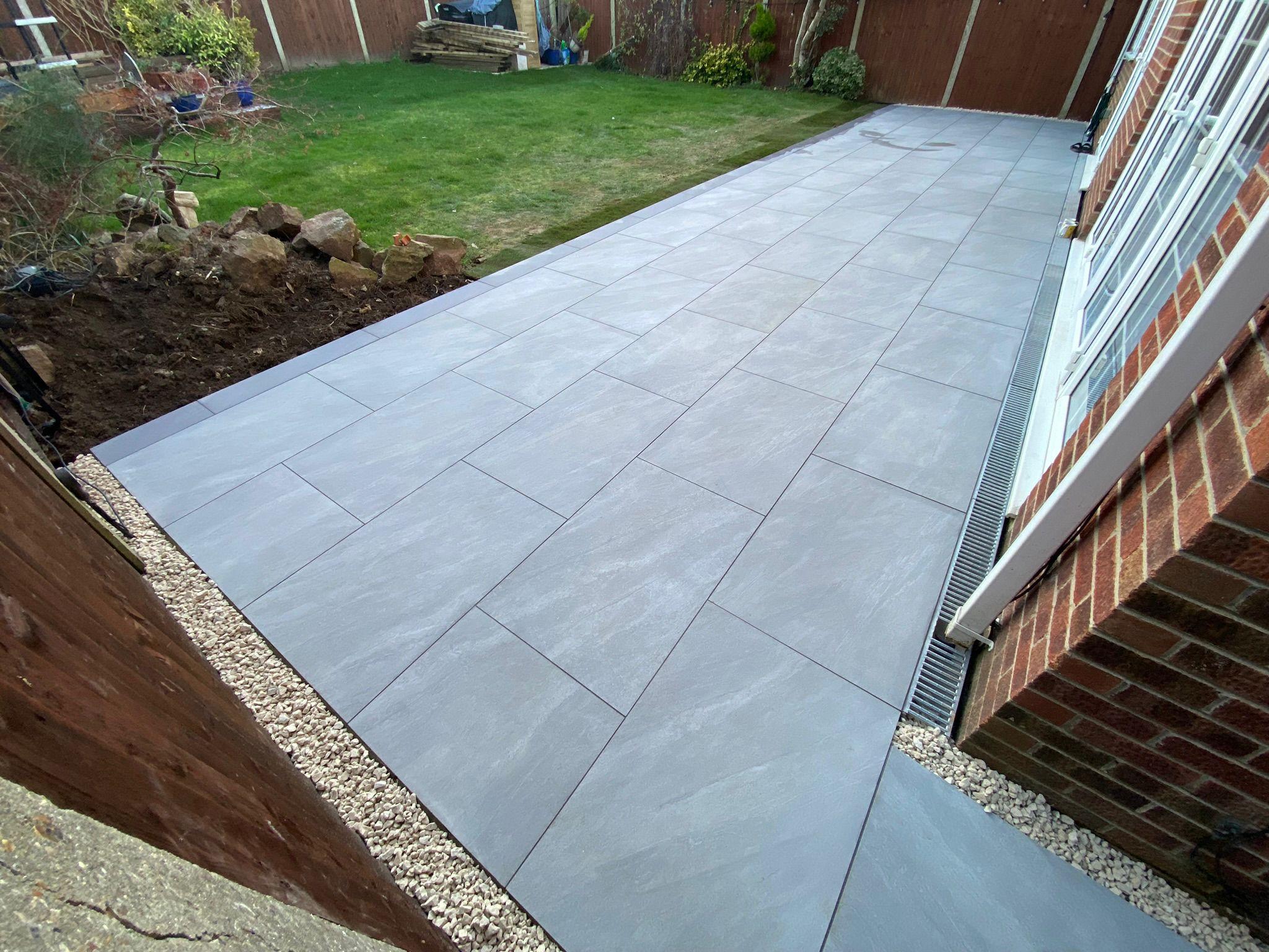 Grey porcelain patio beside conservatory, Surrey
