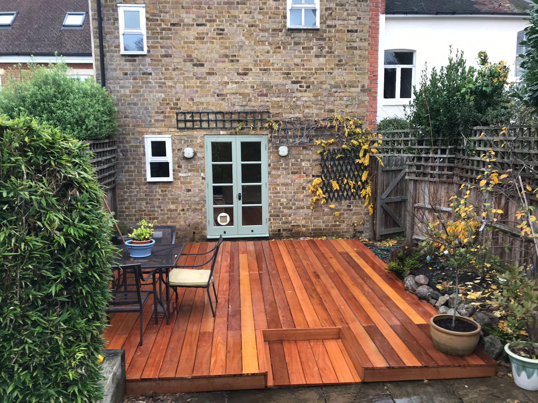 Hardwood timber decking with steps at brick house, Surrey