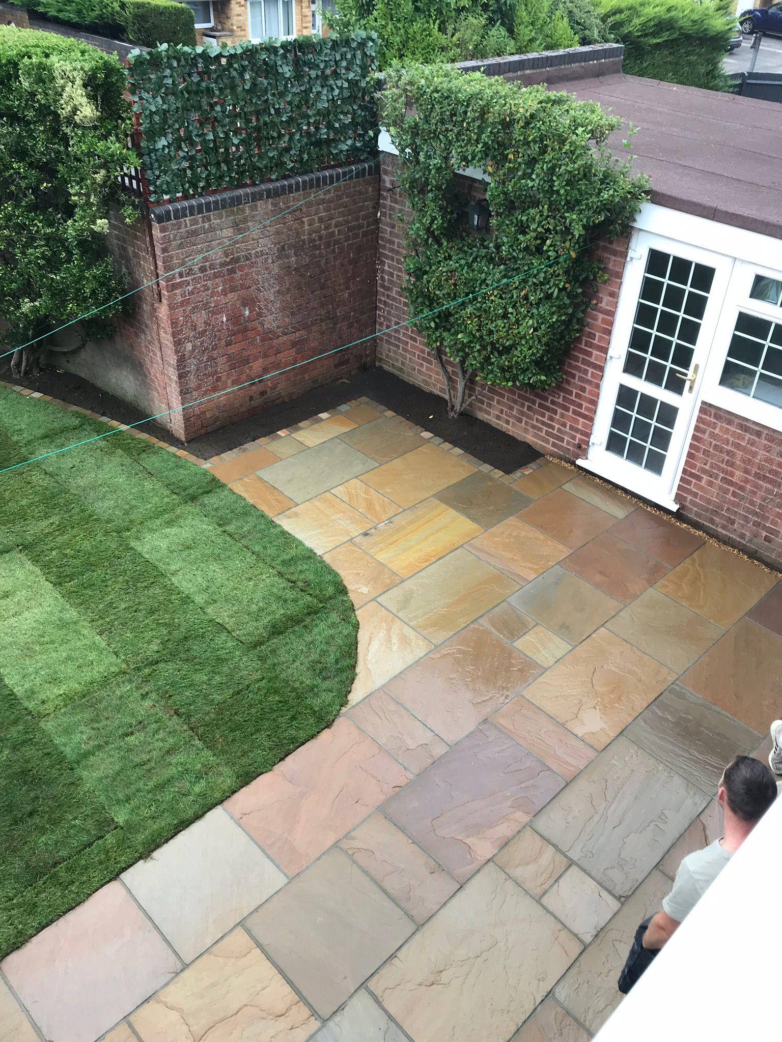 Aerial view of Indian sandstone patio with new turf lawn, Surrey
