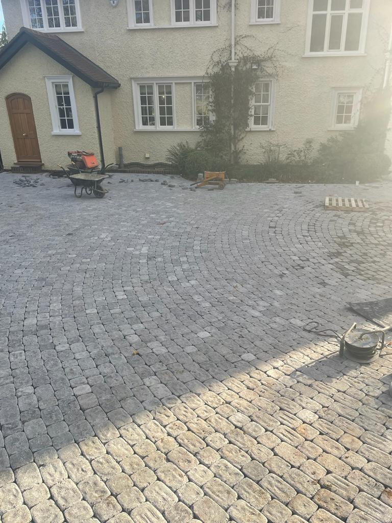 Large granite cobblestone sett driveway being laid, Surrey