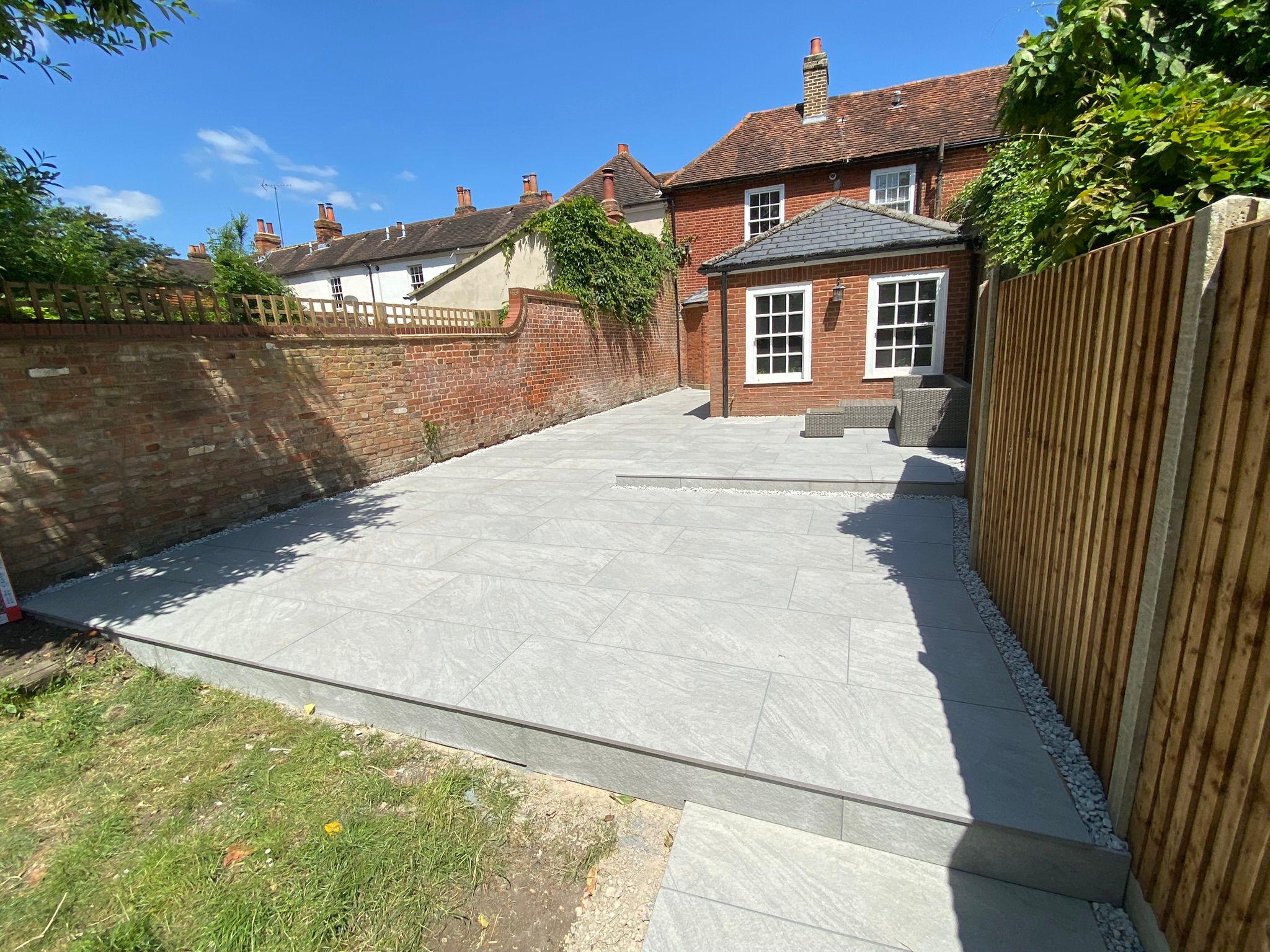 Large grey porcelain patio in rear garden, Surrey