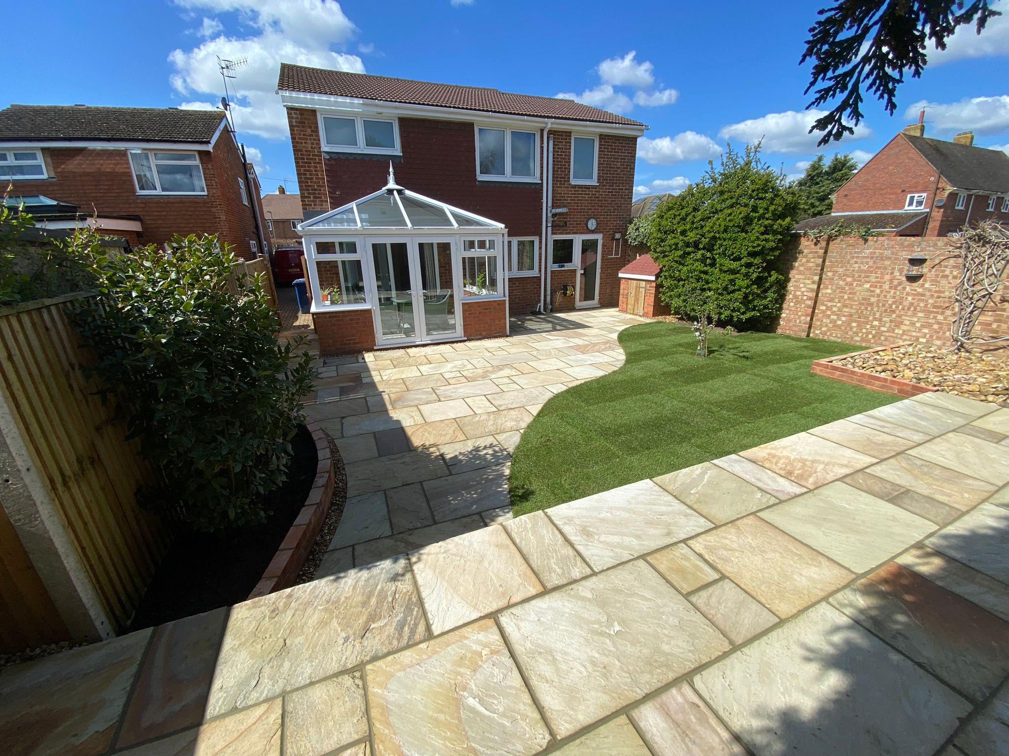 Large Indian sandstone patio with new turf lawn, Surrey