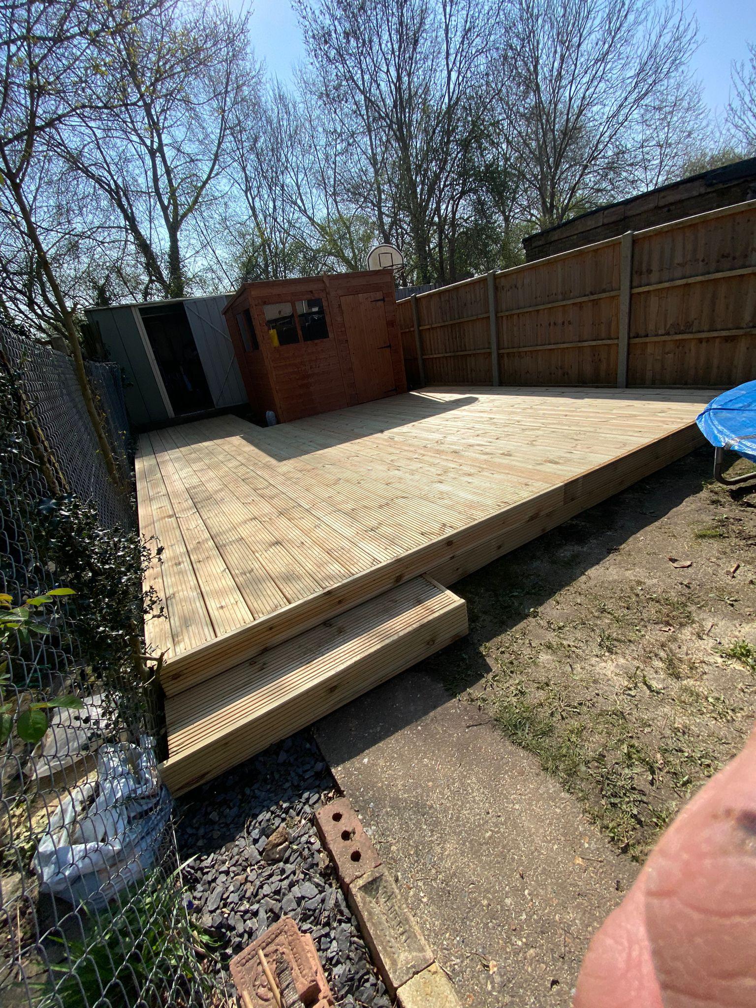 Large pressure-treated decking with steps and shed, Surrey
