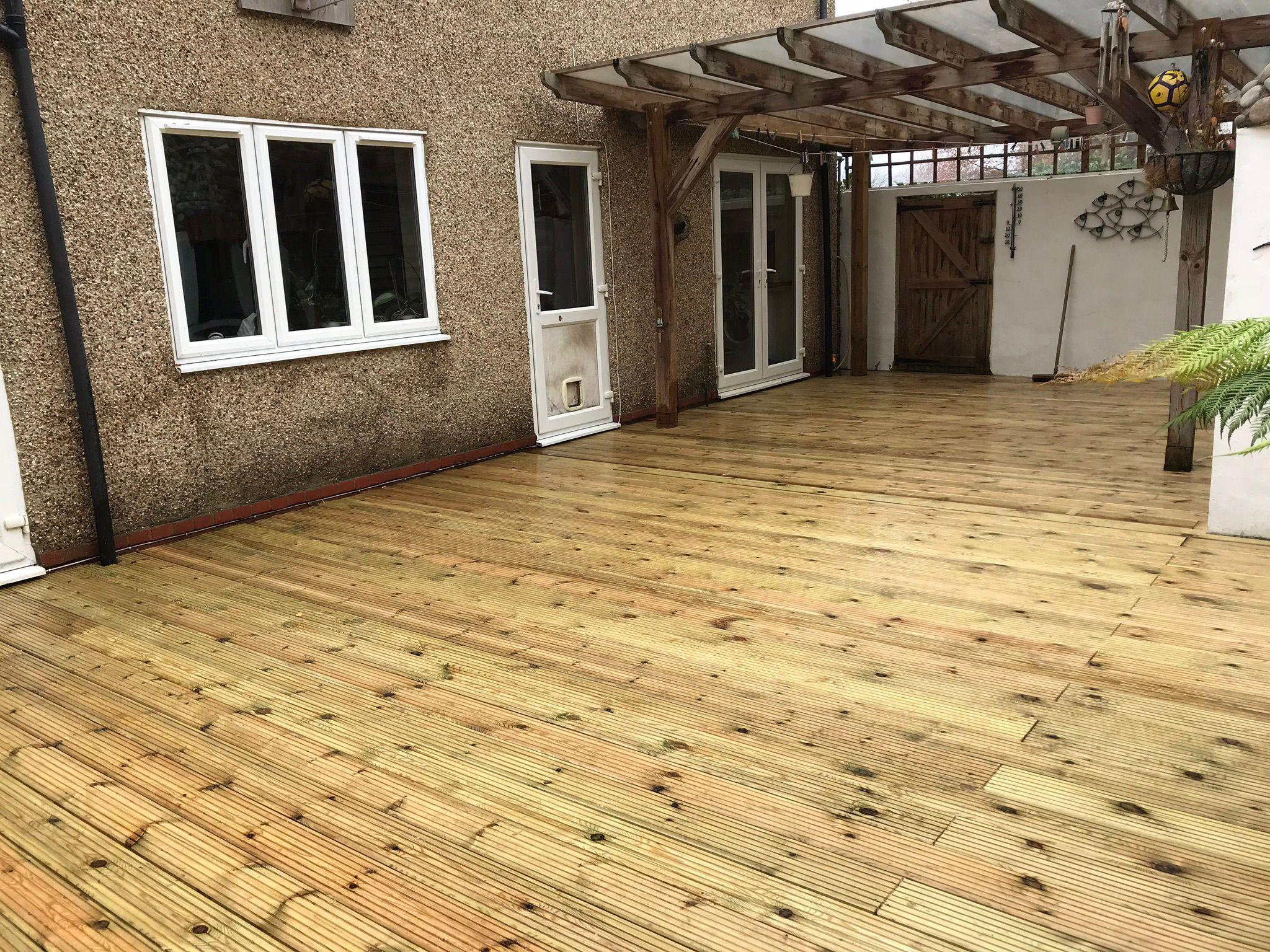 Large timber decking with pergola at rear of house, Surrey