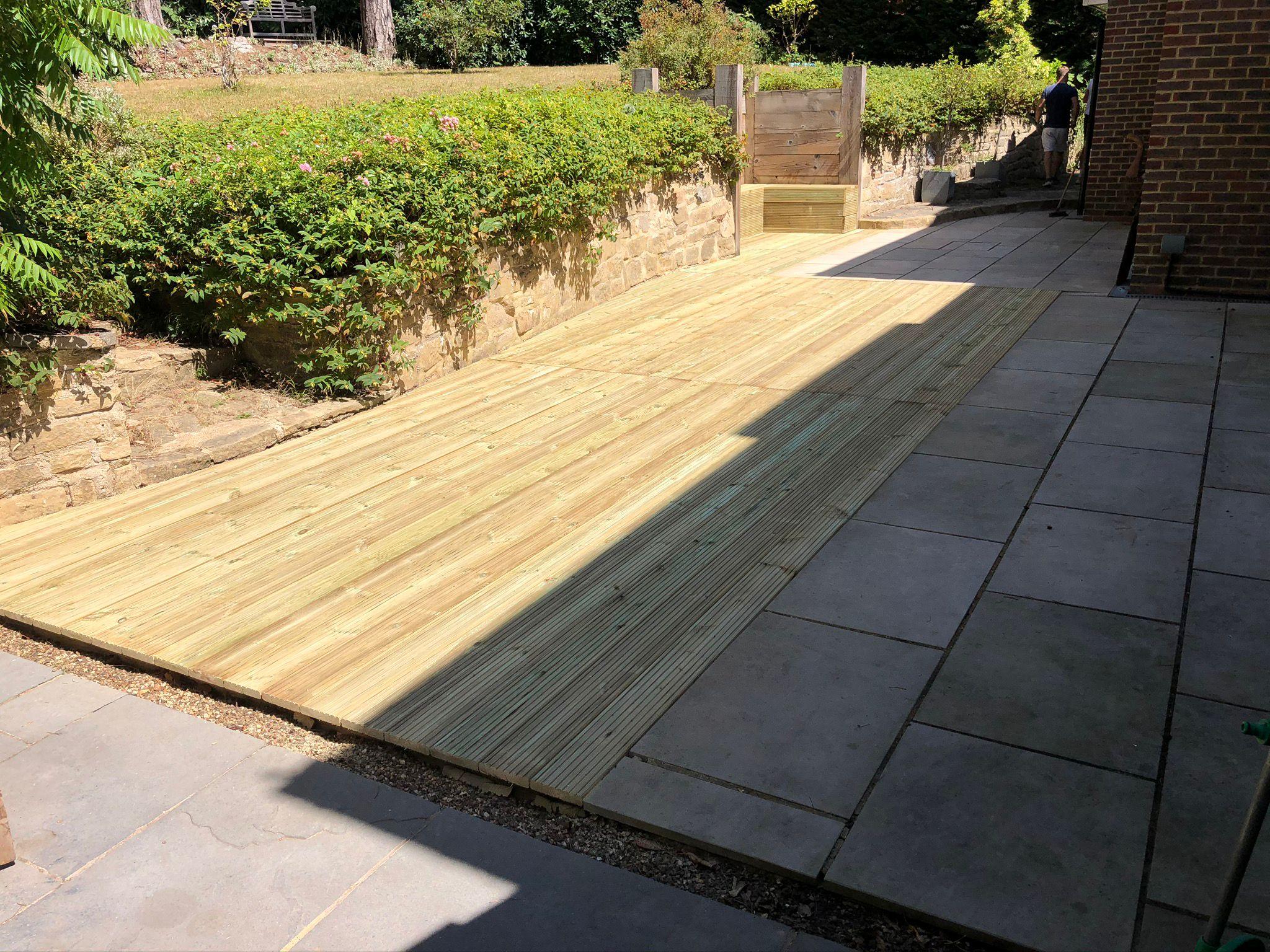 New timber decking with sandstone patio, Surrey