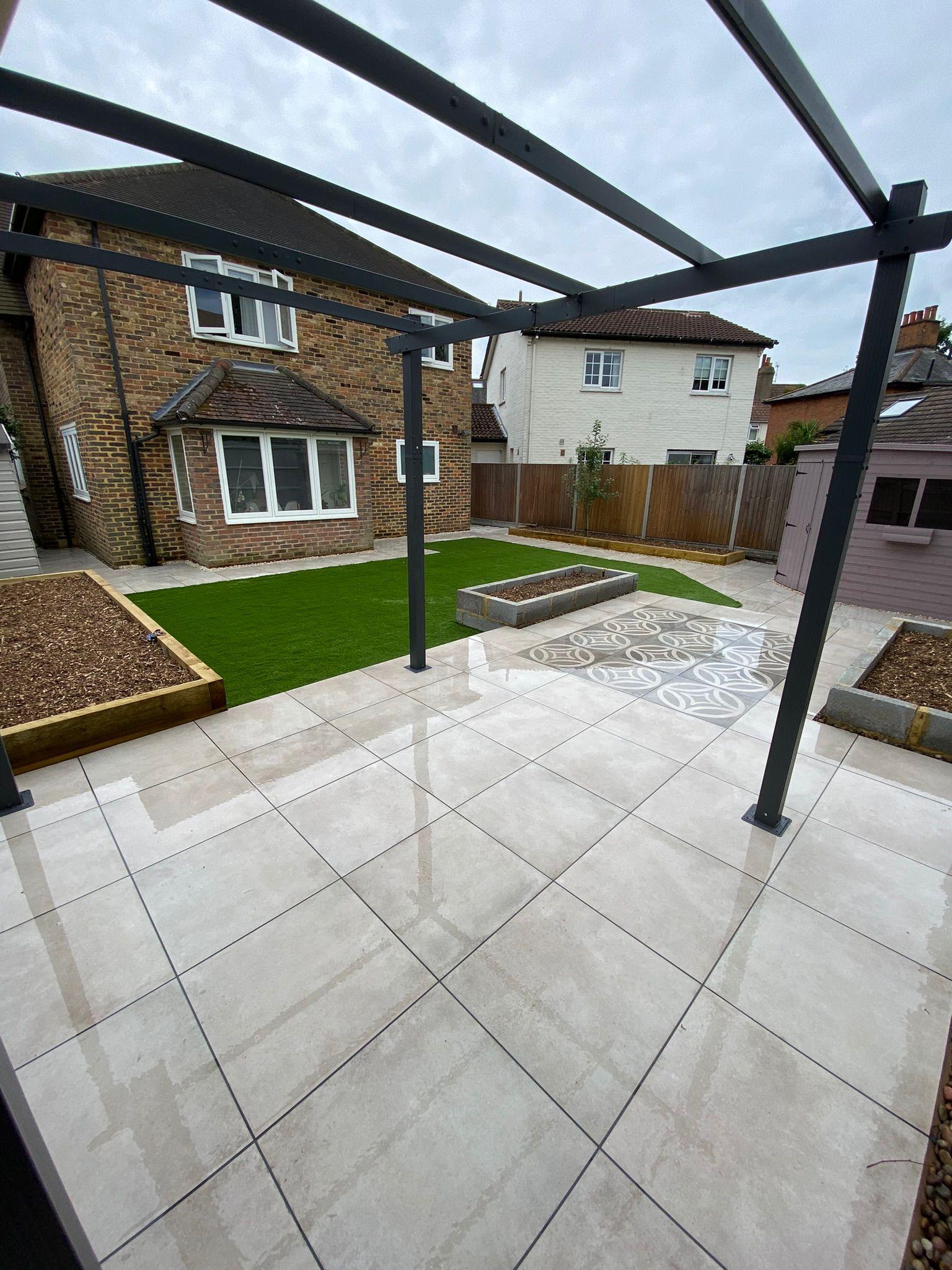 White porcelain patio with pergola and artificial grass, Surrey
